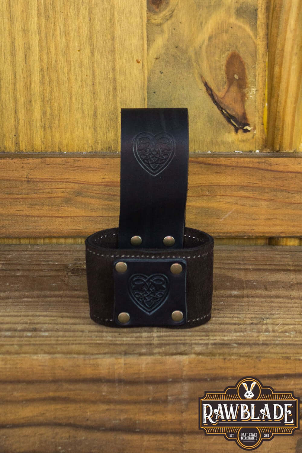 Wanderer Holder featuring Celtic designs, engraved leather, and old gold rivets, crafted by Rawblade.
