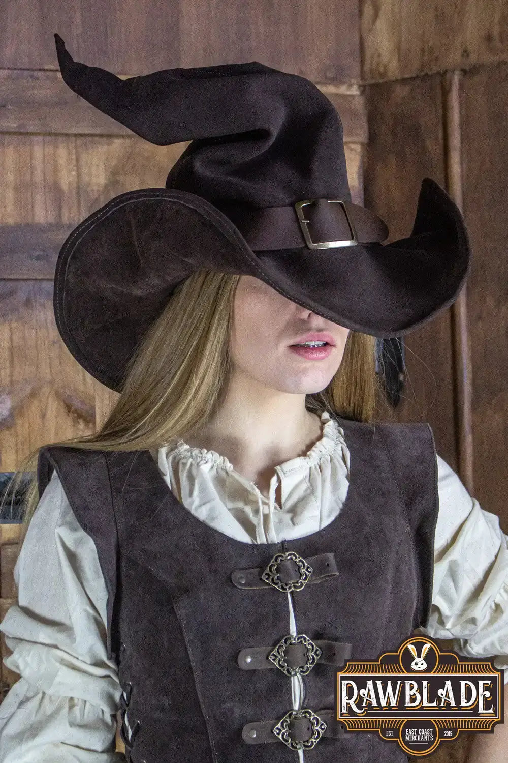 Wikka The Witch Hat Split Leather in brown worn by a model, showcasing its elegant design and leather finish.