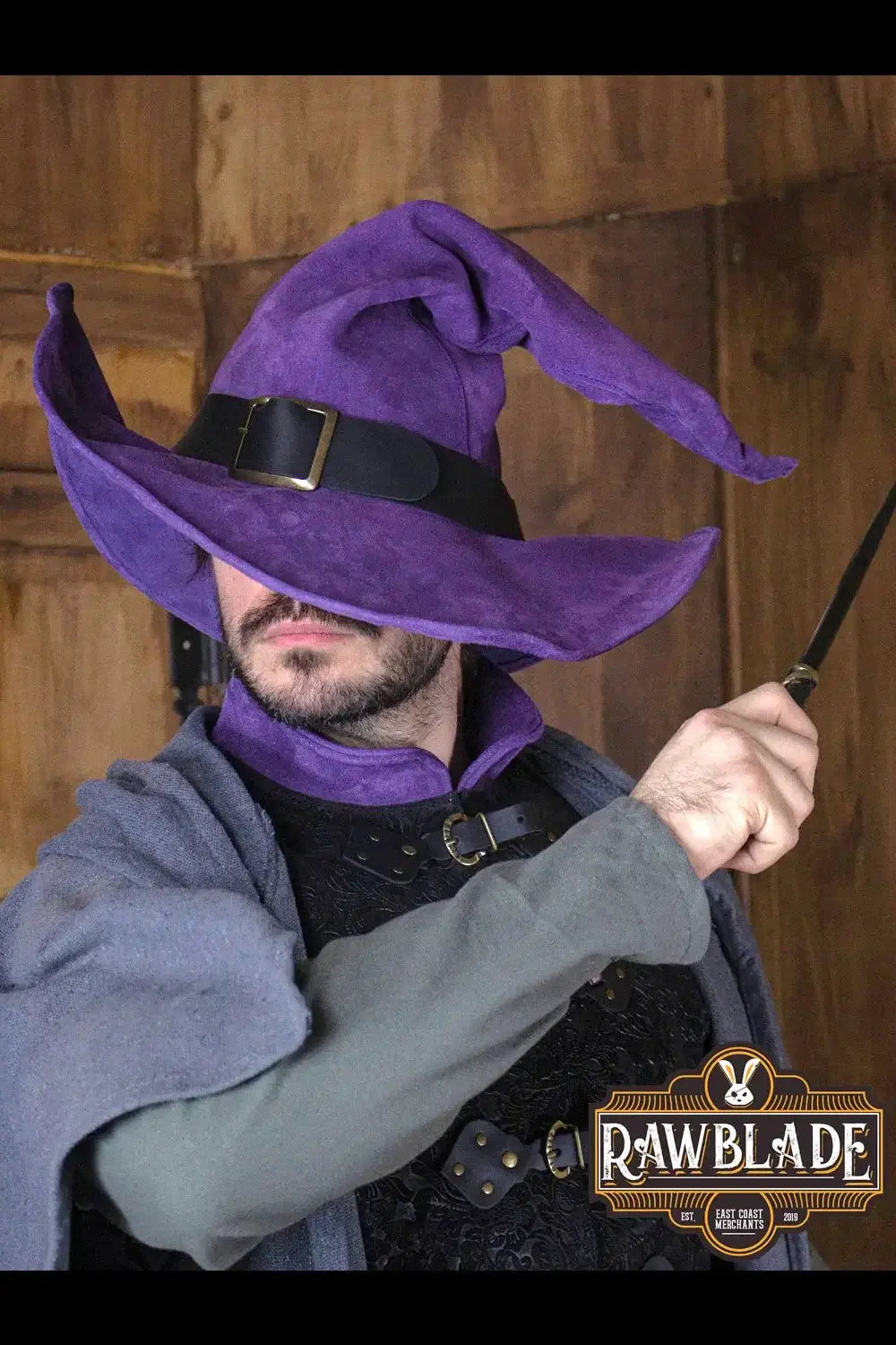 Wikka The Witch Hat Split Leather in purple worn by a character holding a wand, showcasing adjustable wings.